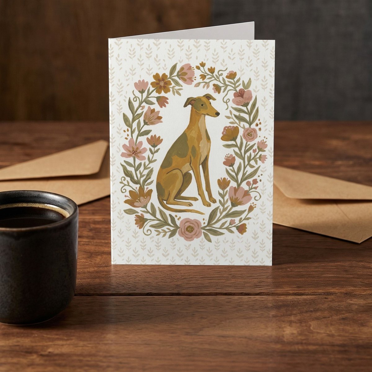 A folded card standing on a rustic wood table beside a mug of coffee